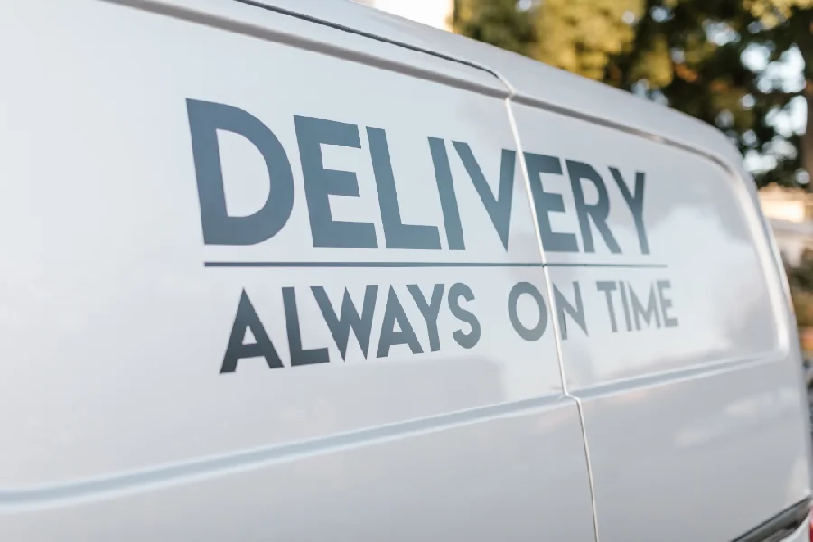 A white van with Delivery Always On Time written on it